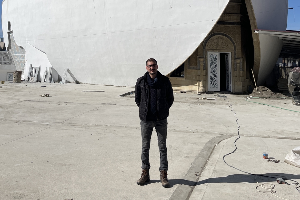 Ezzat Behnam in front of the door of the church in Mosul where his priest was shot and killed in 2007.