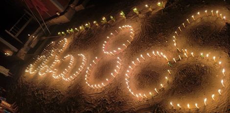 A picture of candles placed in a geometric pattern on the ground in a village in Myanmar.