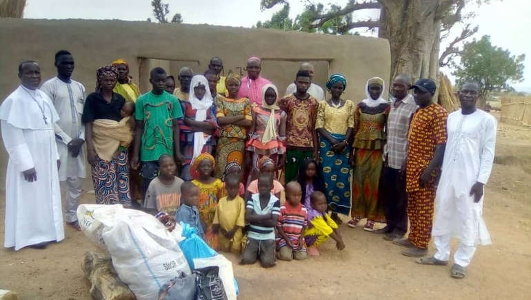 I Chibok i Borno-staten er tusenvis av kristne jaga på flukt av islamistisk terror, her er nokre av dei saman med biskop John Ali Shettima i raud drakt i midten bak.